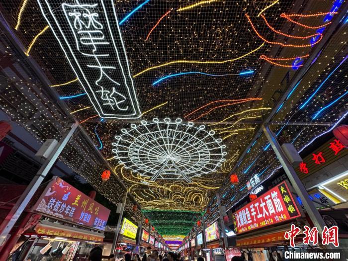圖為明清街夜市燈光點(diǎn)亮具有武威文化元素的“摩天輪”彩燈?！〈魑牟?攝</p><p>