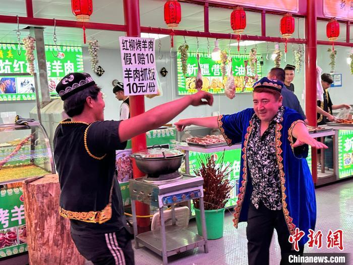 圖為餐飲經(jīng)營(yíng)者在“西涼不夜城”跳起舞蹈引客?！〈魑牟?攝</p><p>